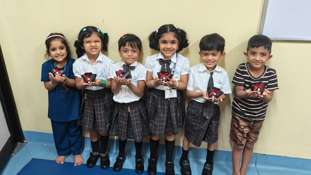 LKG children holding handmade gift crafts at Galaxy Infant School