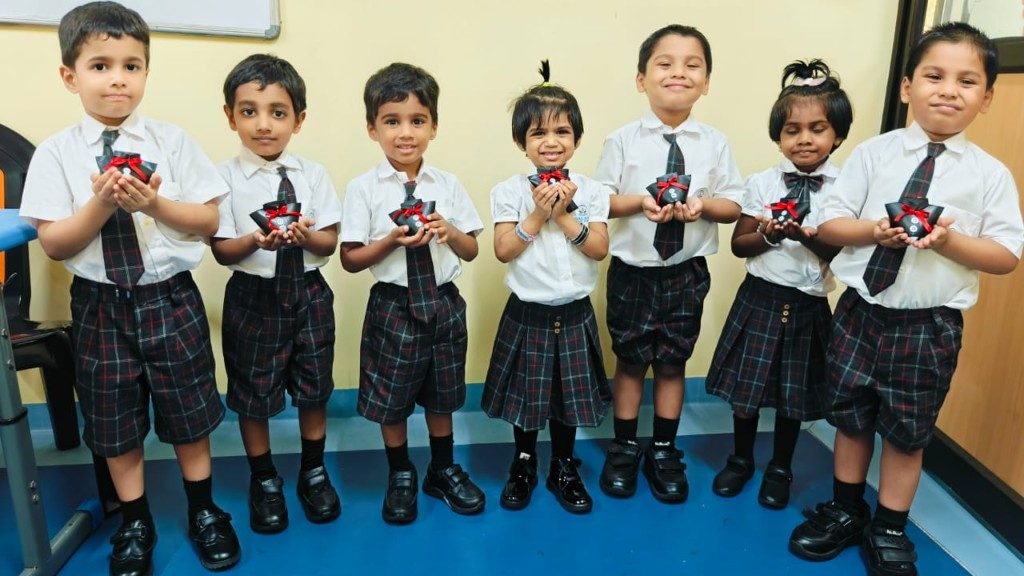 LKG students in Galaxy uniforms holding gift crafts