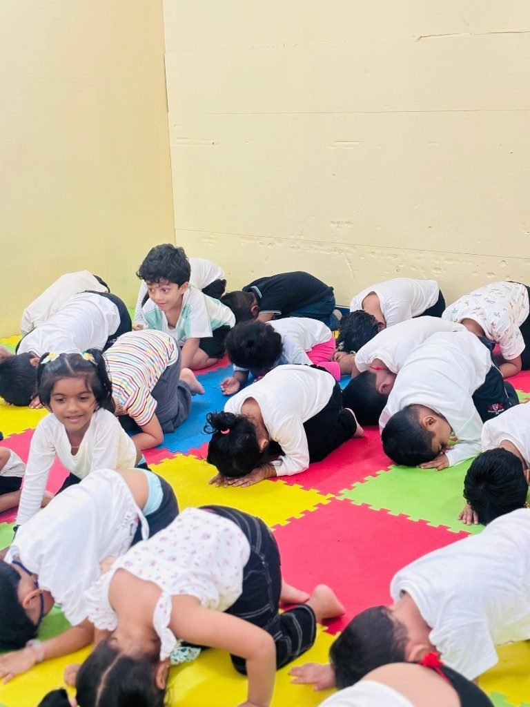 Children resting in child's pose during classroom yoga