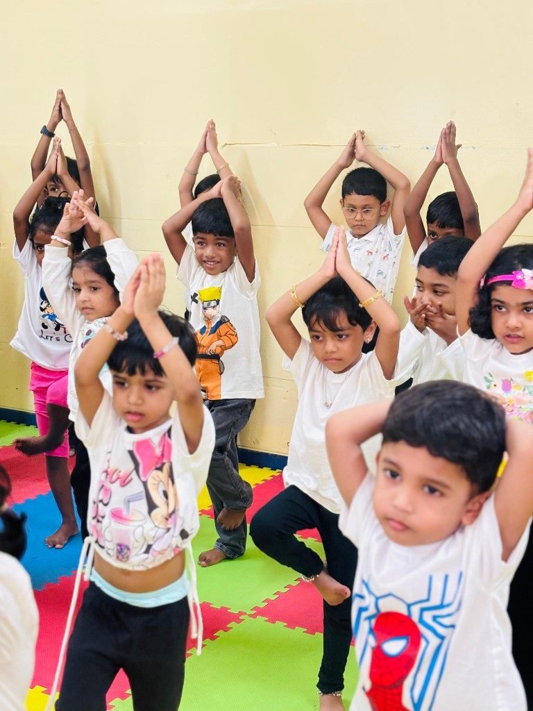 Children practicing yoga tree pose at Galaxy Infant School